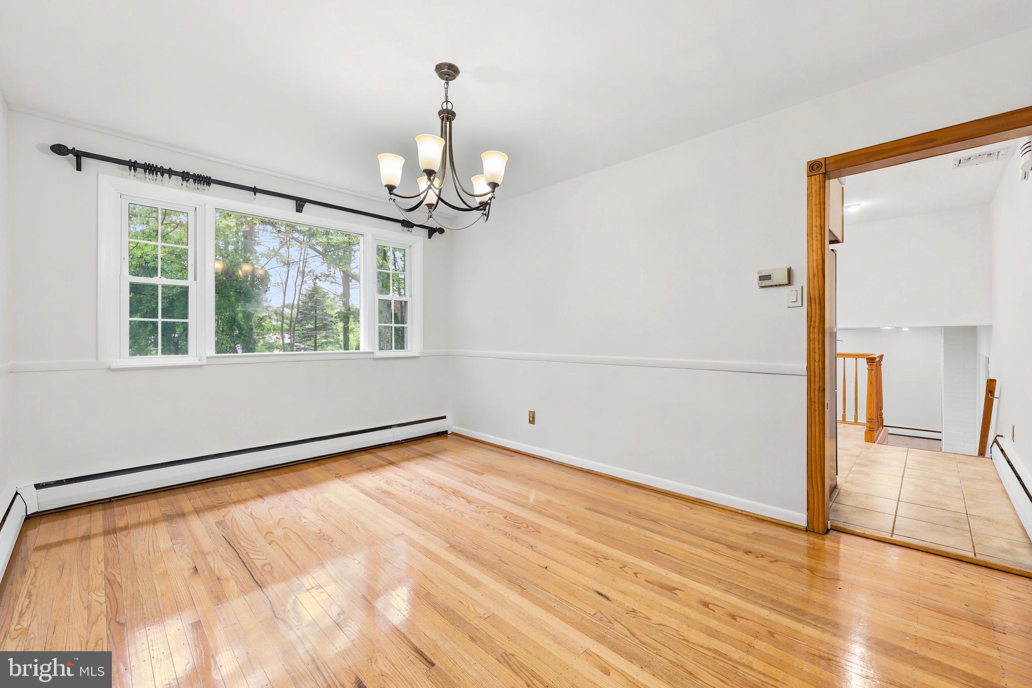 412 Yorkshire Road Bryn Mawr, PA 19010 - Photo 9 of 25 a view of empty room with wooden floor and fan