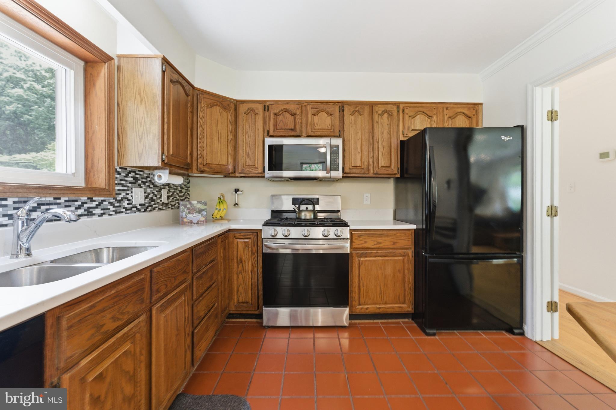 2100 Edgewater Parkway Silver Spring, MD 20903 - Photo 11 of 46 a kitchen with a refrigerator sink and a stove