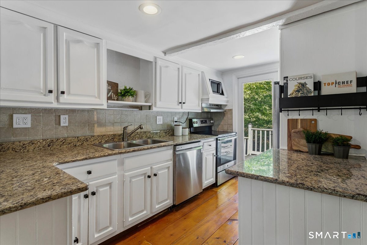 188 Bacon Road Roxbury, CT 06783 - Photo 8 of 33 a kitchen with granite countertop a sink a stove and cabinets
