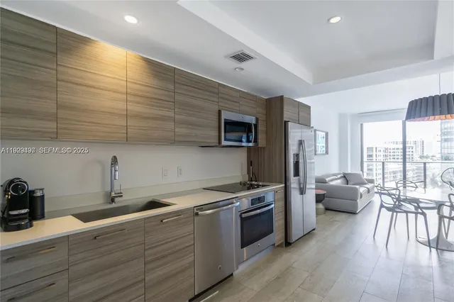 a kitchen with stainless steel appliances a stove sink and cabinets