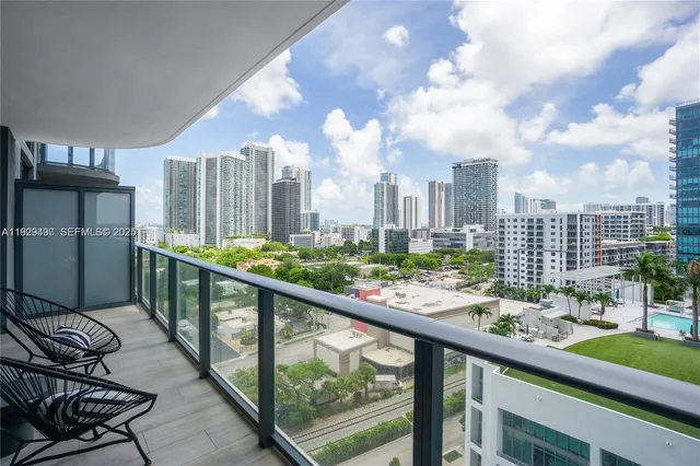 a view of a city from a balcony with furniture