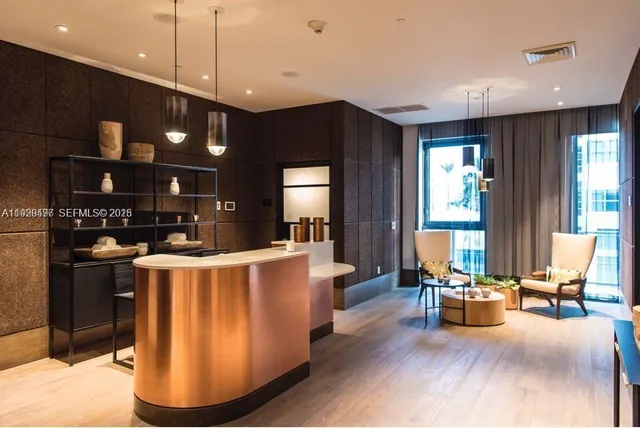 a living room with stainless steel appliances kitchen island granite countertop furniture a rug a kitchen and a sink