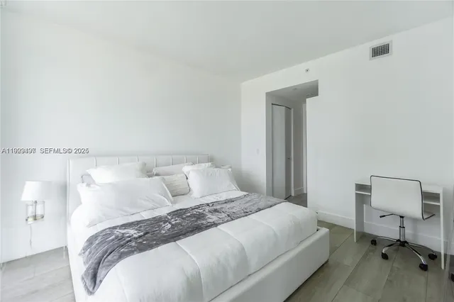 a bedroom with a bed and a chair