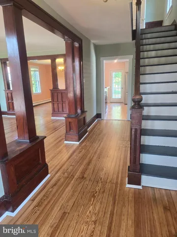 a view of an empty room and wooden floor