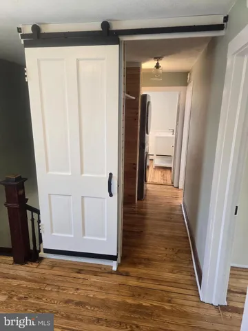 a view of hallway with wooden floor