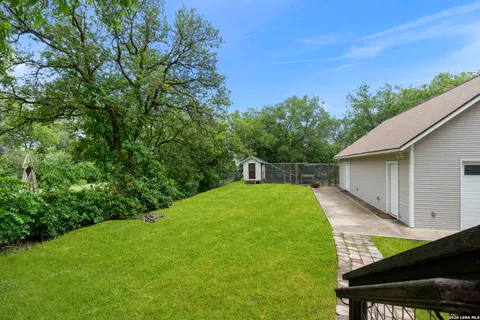 a backyard with a table and chairs