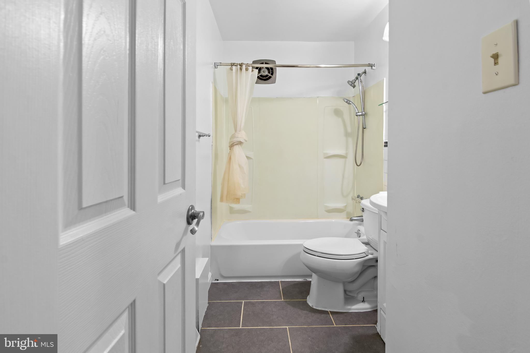 4415 Falls Bridge Drive, Unit K Baltimore, MD 21211 - Photo 12 of 18 a bathroom with a sink toilet and shower