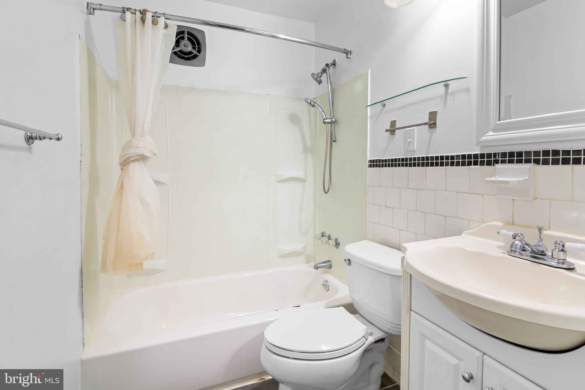 4415 Falls Bridge Drive, Unit K Baltimore, MD 21211 - Photo 13 of 18 a bathroom with a sink toilet and shower