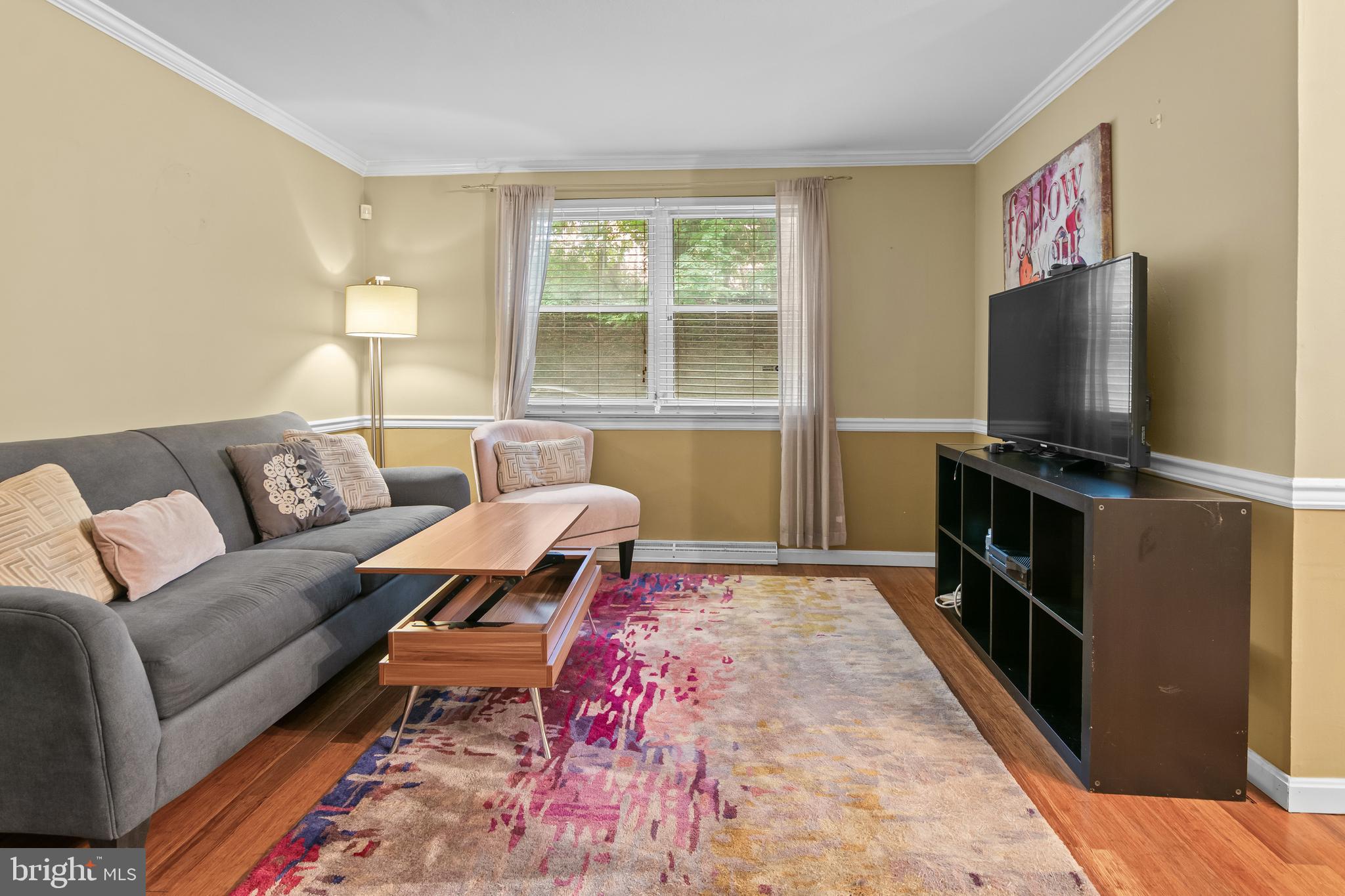 4415 Falls Bridge Drive, Unit K Baltimore, MD 21211 - Photo 2 of 18 a living room with furniture and a flat screen tv