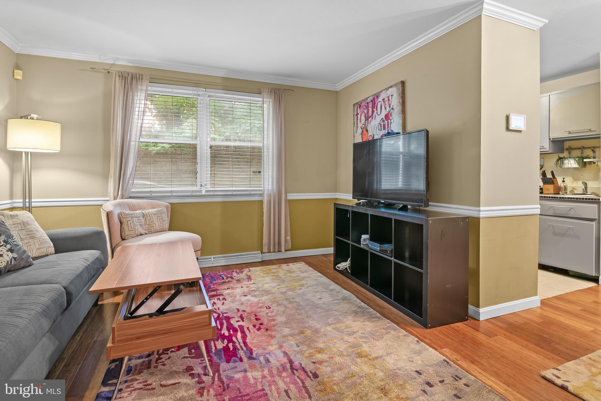 4415 Falls Bridge Drive, Unit K Baltimore, MD 21211 - Photo 4 of 18 a living room with furniture and a flat screen tv