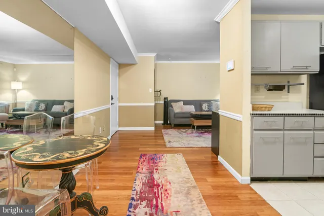 a kitchen with cabinets and wooden floor