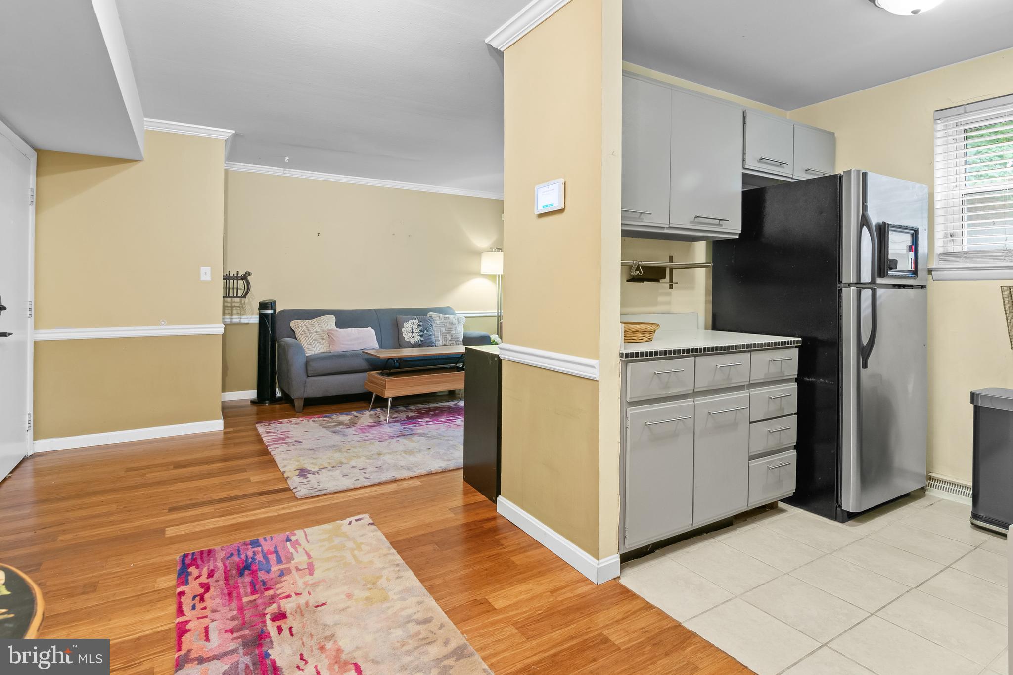 4415 Falls Bridge Drive, Unit K Baltimore, MD 21211 - Photo 8 of 18 a kitchen with cabinets and wooden floor
