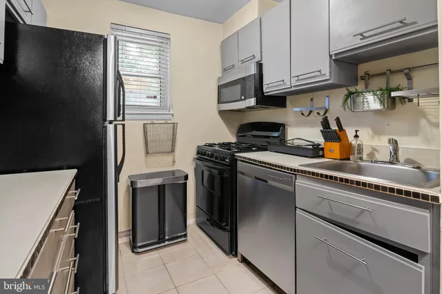 a kitchen with a refrigerator stove and cabinets