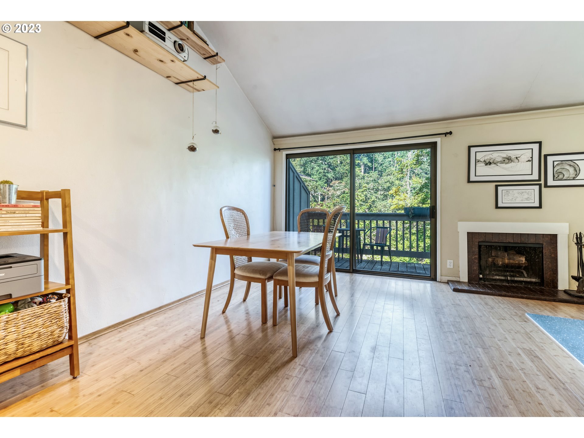 422 Stonewood Drive Eugene, OR 97405 - Photo 12 of 32 a dining room with furniture a fireplace and wooden floor