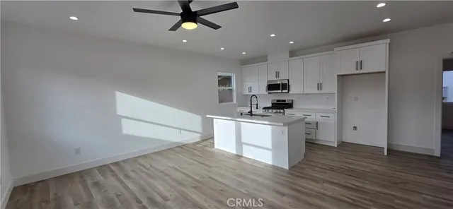 a kitchen with a refrigerator and a stove top oven