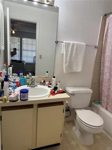 a bathroom with a sink toilet and mirror