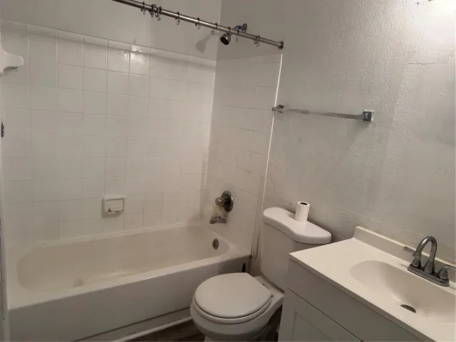 a bathroom with a sink a toilet and a bathtub