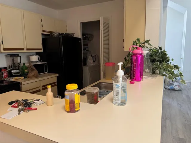 a kitchen with a refrigerator and a stove