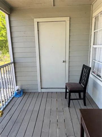 a view of a house with wooden floor and bench