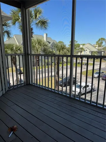 a view of balcony with wooden floor