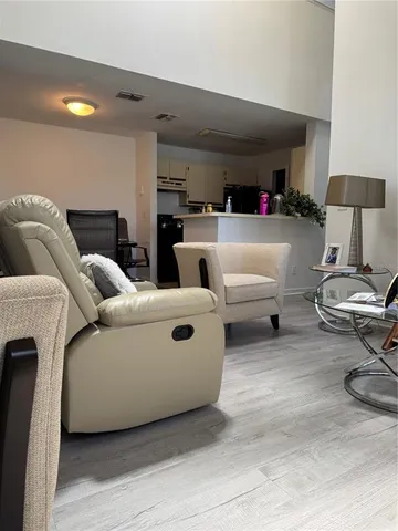 a living room with furniture and a lamp