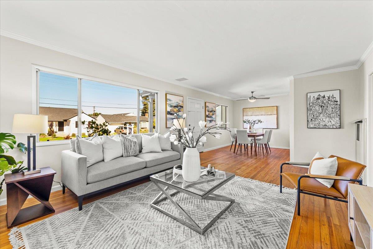 a living room with furniture dining table and a flat screen tv