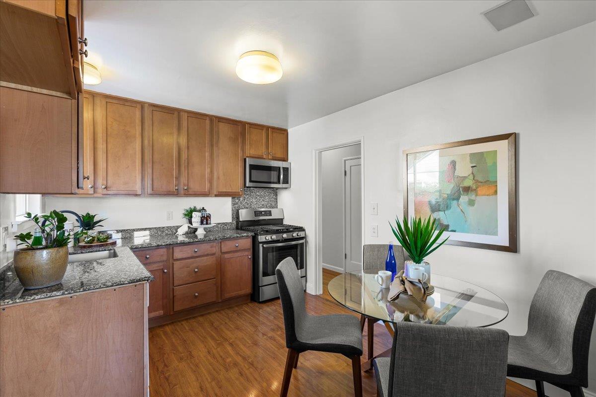 1100 Irwin Street Belmont, CA 94002 - Photo 17 of 53 a kitchen with a potted plant in it and wooden floors