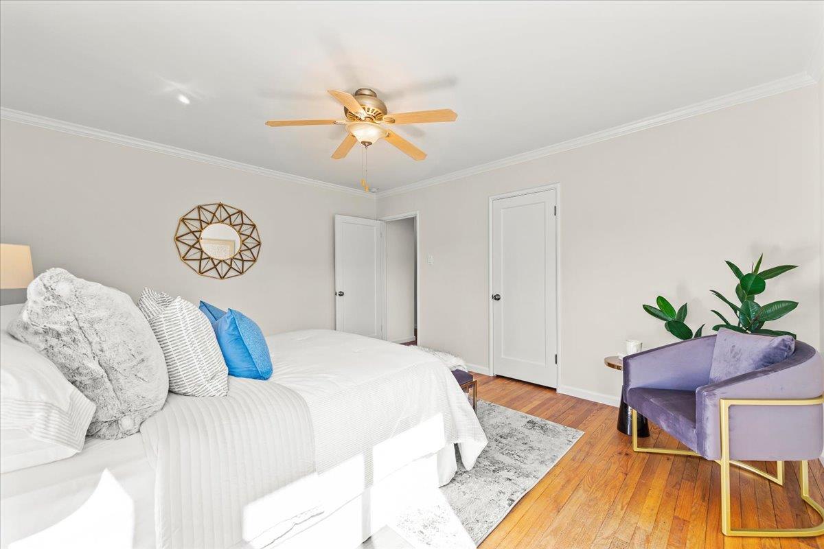 1100 Irwin Street Belmont, CA 94002 - Photo 25 of 53 a bedroom with a bed and a chandelier