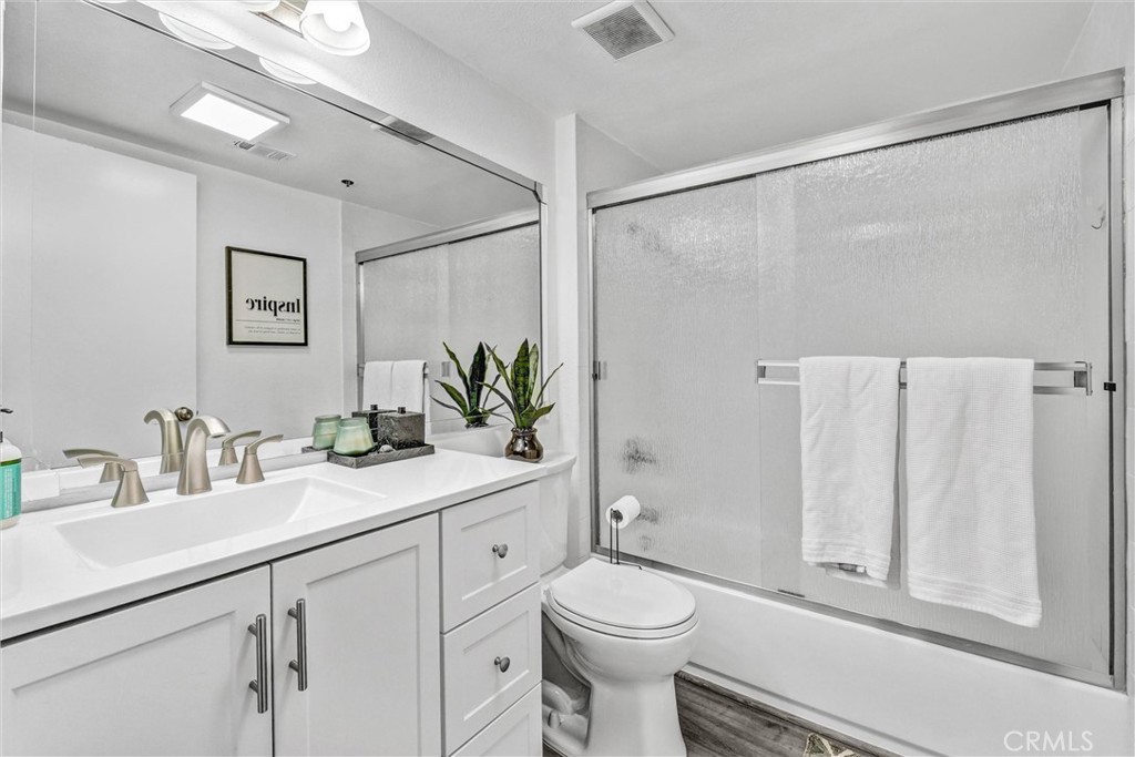 6545 Reseda Boulevard, Unit 6 Reseda, CA 91335 - Photo 14 of 32 a bathroom with a toilet a sink and a large mirror