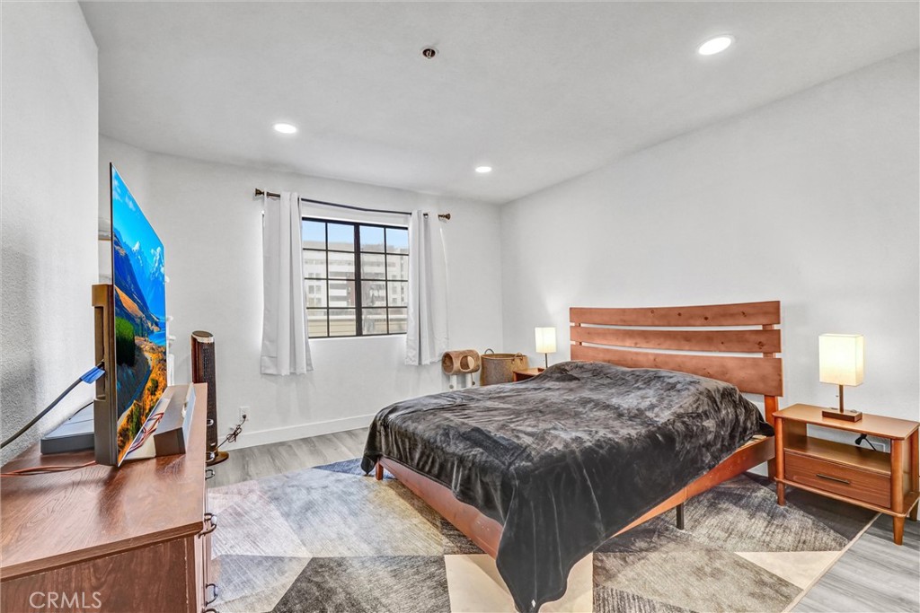 6545 Reseda Boulevard, Unit 6 Reseda, CA 91335 - Photo 16 of 32 a bedroom with a bed and a flat screen tv