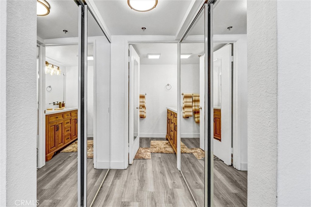 6545 Reseda Boulevard, Unit 6 Reseda, CA 91335 - Photo 18 of 32 a view of a hallway with wooden floor and a bathroom