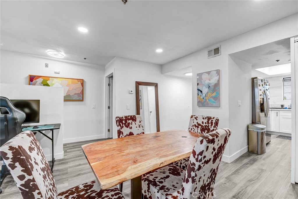 6545 Reseda Boulevard, Unit 6 Reseda, CA 91335 - Photo 4 of 32 a view of a dining room with furniture and wooden floor