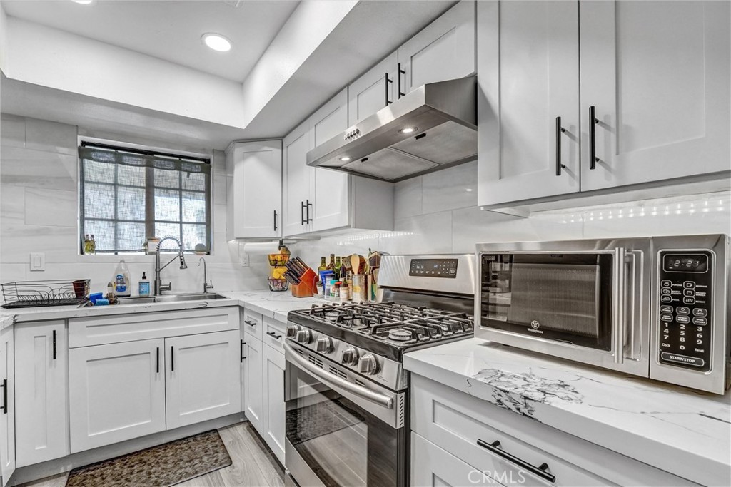 6545 Reseda Boulevard, Unit 6 Reseda, CA 91335 - Photo 5 of 32 a kitchen with cabinets appliances and a counter