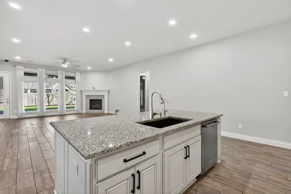 a kitchen with stainless steel appliances granite countertop a sink and stove