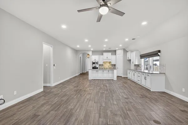 a view of kitchen with cabinets and wooden floor