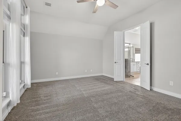a view of an empty room with a bathroom