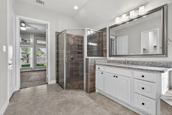 a bathroom with a granite countertop sink mirror and