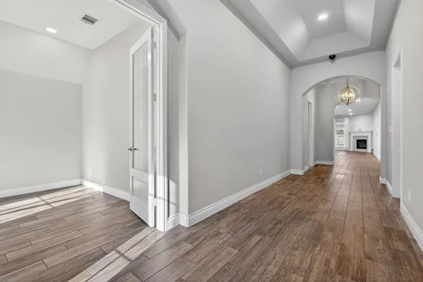 a view of a hallway with wooden floor