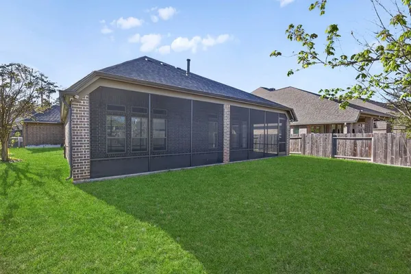 a view of a house with a yard and a garden