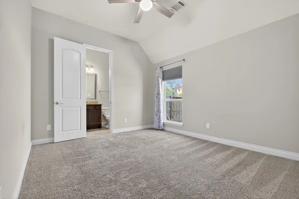 an empty room with fan and windows