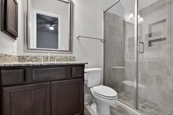 a bathroom with a sink toilet and shower