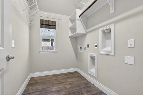 a view of a hallway with wooden floor and entryway