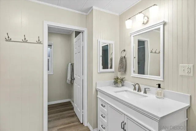 a bathroom with a sink vanity granite and a mirror
