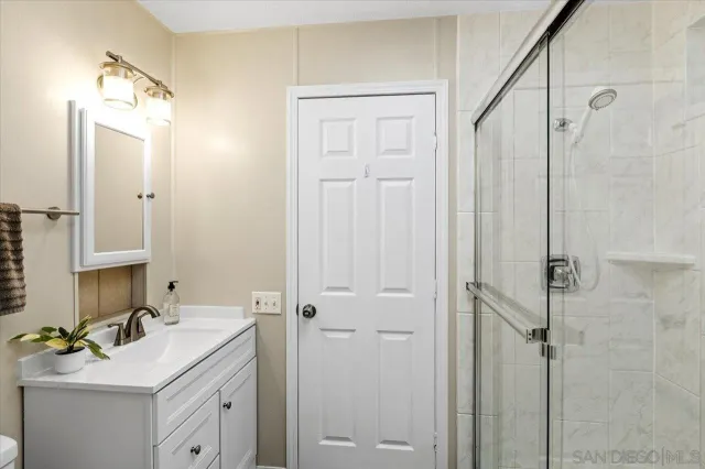 a bathroom with a sink vanity tub and shower