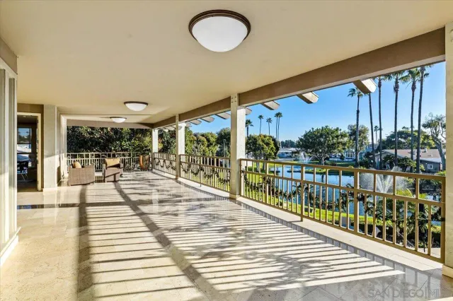 a view of roof deck with couches and wooden fence