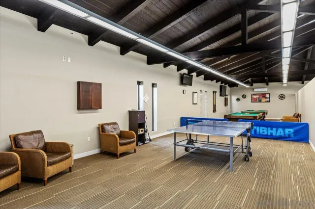 a room with pool table and wooden floor