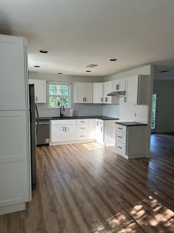a view of a kitchen with a sink stainless steel appliances and cabinets