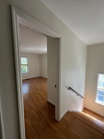 a view of a roof deck with wooden floor and fence