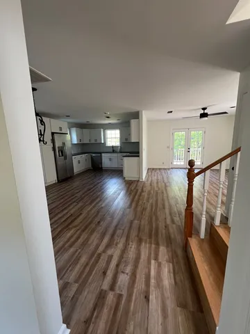 a view of a living room with wooden floor