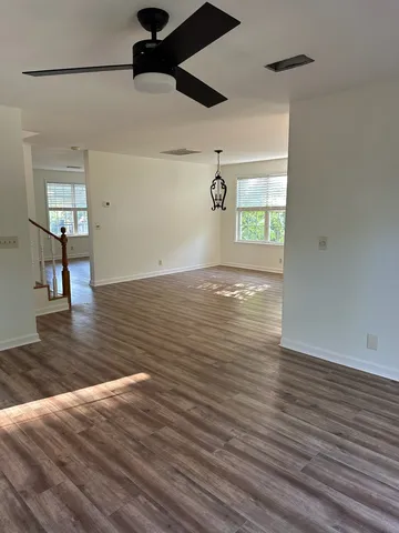 a view of empty room with wooden floor
